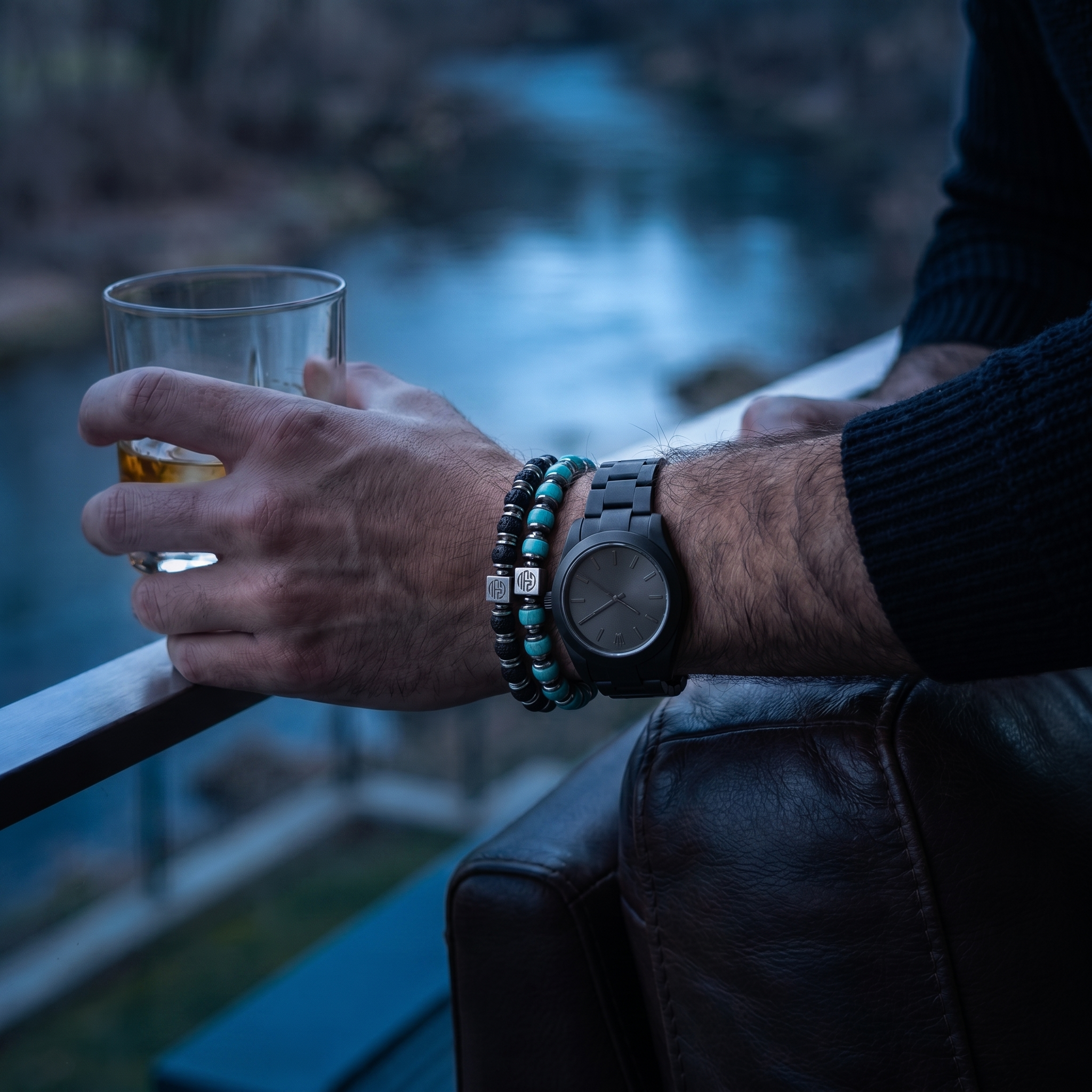 Man holding a glass with a blurred river nature background
