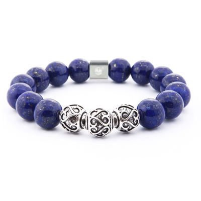A beaded stretch bracelet featuring deep blue lapis lazuli stones and three ornate silver filigree spacer beads, shown on a plain white background.
